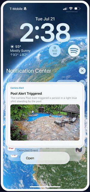 A phone alert from IC Bunker: the camera Pool East saw a person in a light blue shirt standing by the pool, with a snapshot of the pool deck