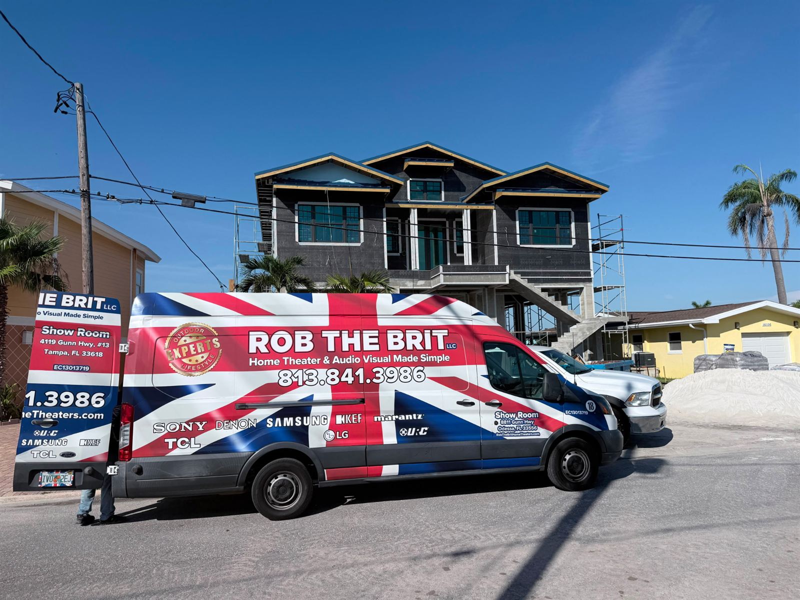 A Rob the Brit van outside a new home under construction