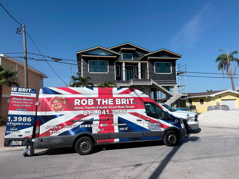 A Rob the Brit van outside a new home under construction