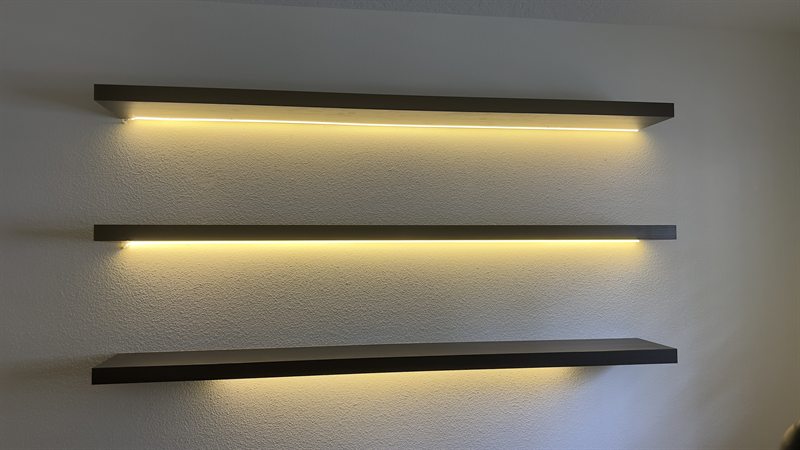 Floating shelves with LED strip lighting underneath