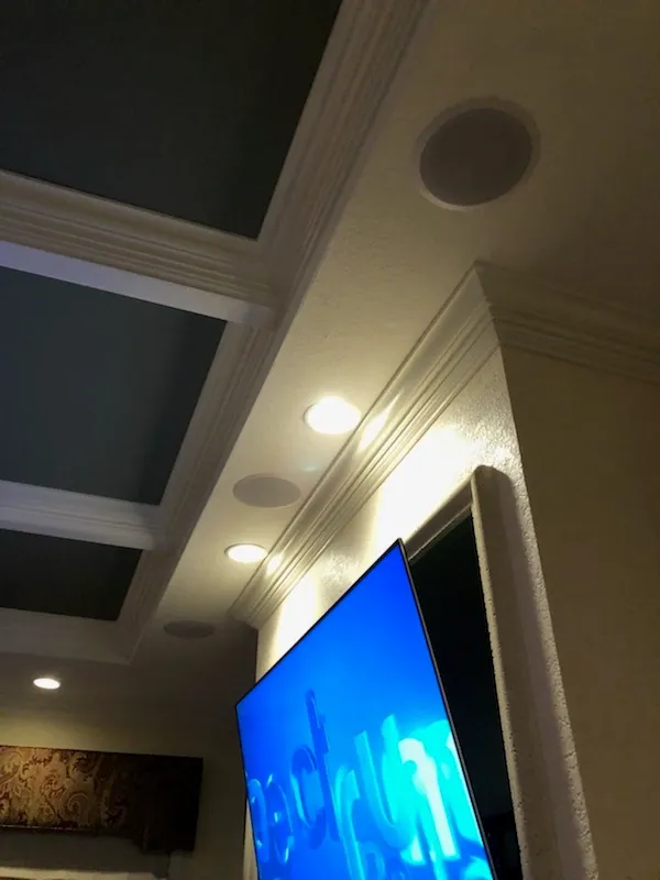 In-ceiling speakers in a tray ceiling above a TV