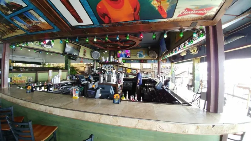 Bar with a row of TVs above the counter