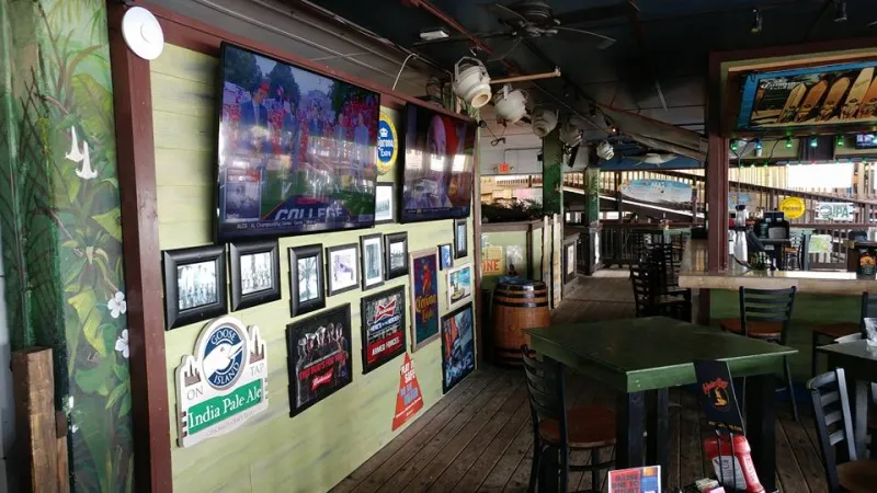 Sports bar TVs among framed photos