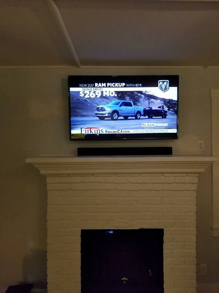 TV and soundbar above a fireplace mantel