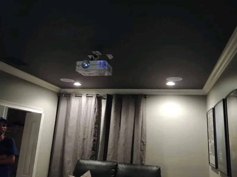 Theater room with a ceiling projector and curtains