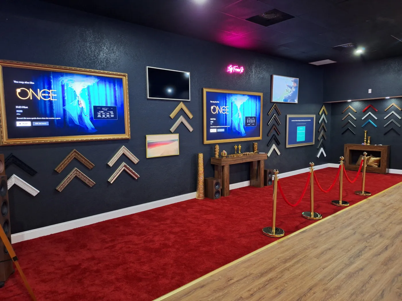 Showroom hall with framed TVs and brass rope posts