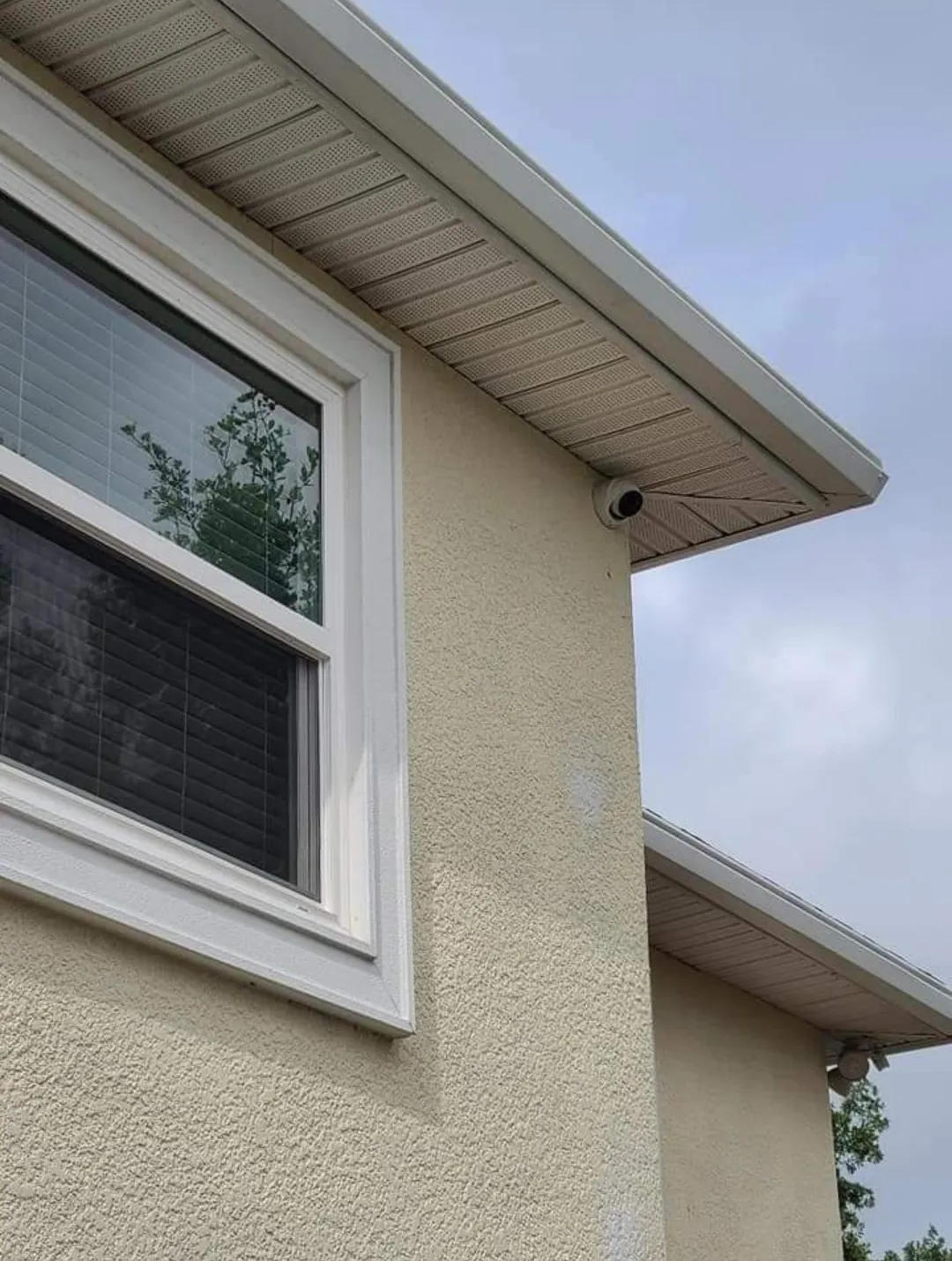 Security camera under a roof eave