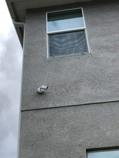 Security camera on a stucco wall