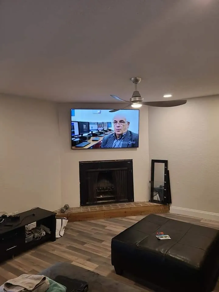 TV mounted over a corner fireplace