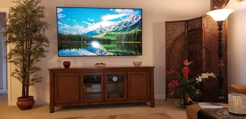 TV above a wood media console