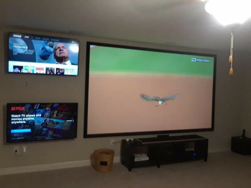 Projection screen and TVs in a game room