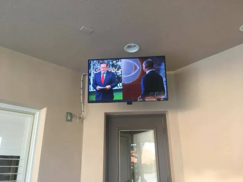 TV mounted high above a doorway