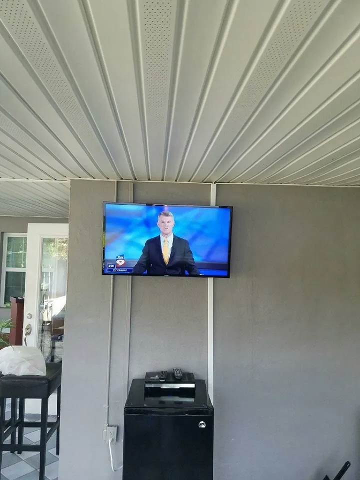 TV mounted on a porch wall