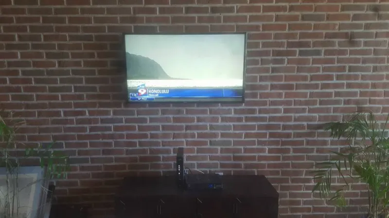 TV mounted on a brick wall